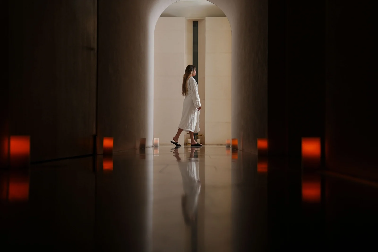 A guest walks through the spa’s lantern-lit corridor.